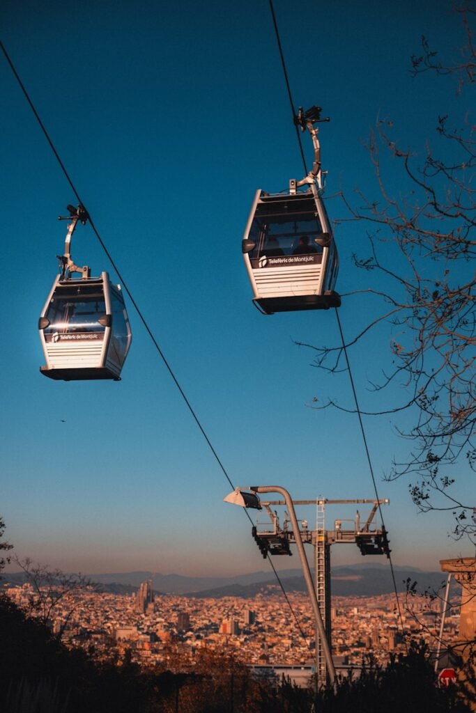 A couple of gondolas that are above a city